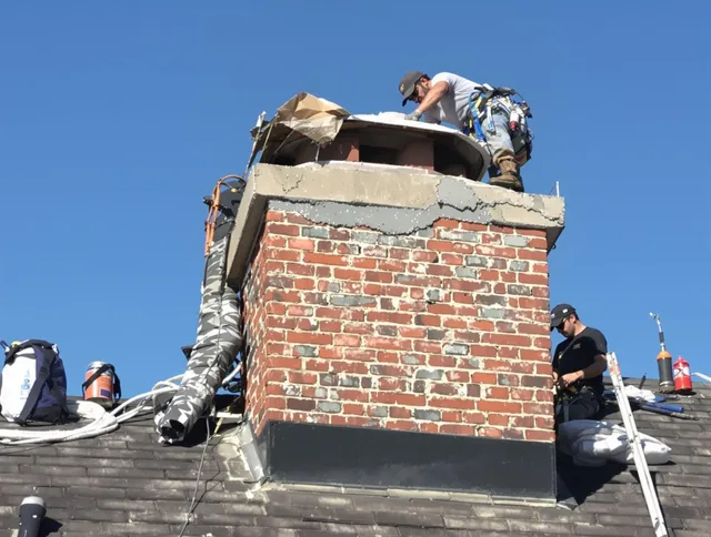 West Warwick Chimney Sweep installing a custom chimney crown in West Warwick, RI