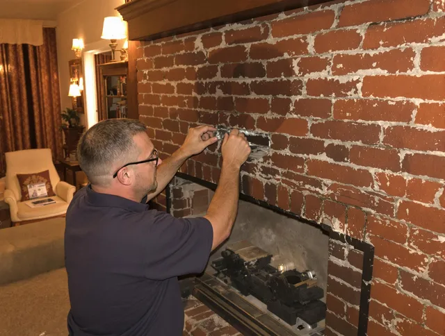 West Warwick Chimney Sweep expert fixing a fireplace in West Warwick, RI